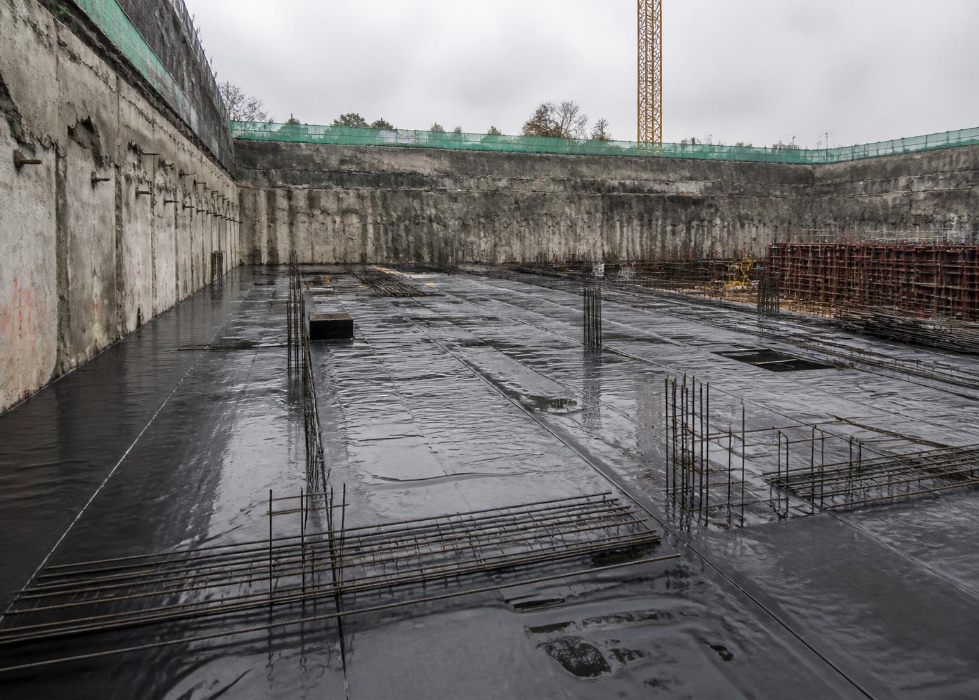 HDPE waterproofing membrane laid over a basement raft foundation with reinforcement bars